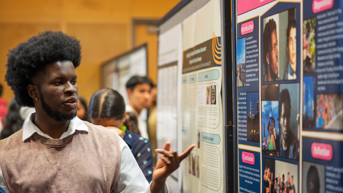 Student presenting research poster