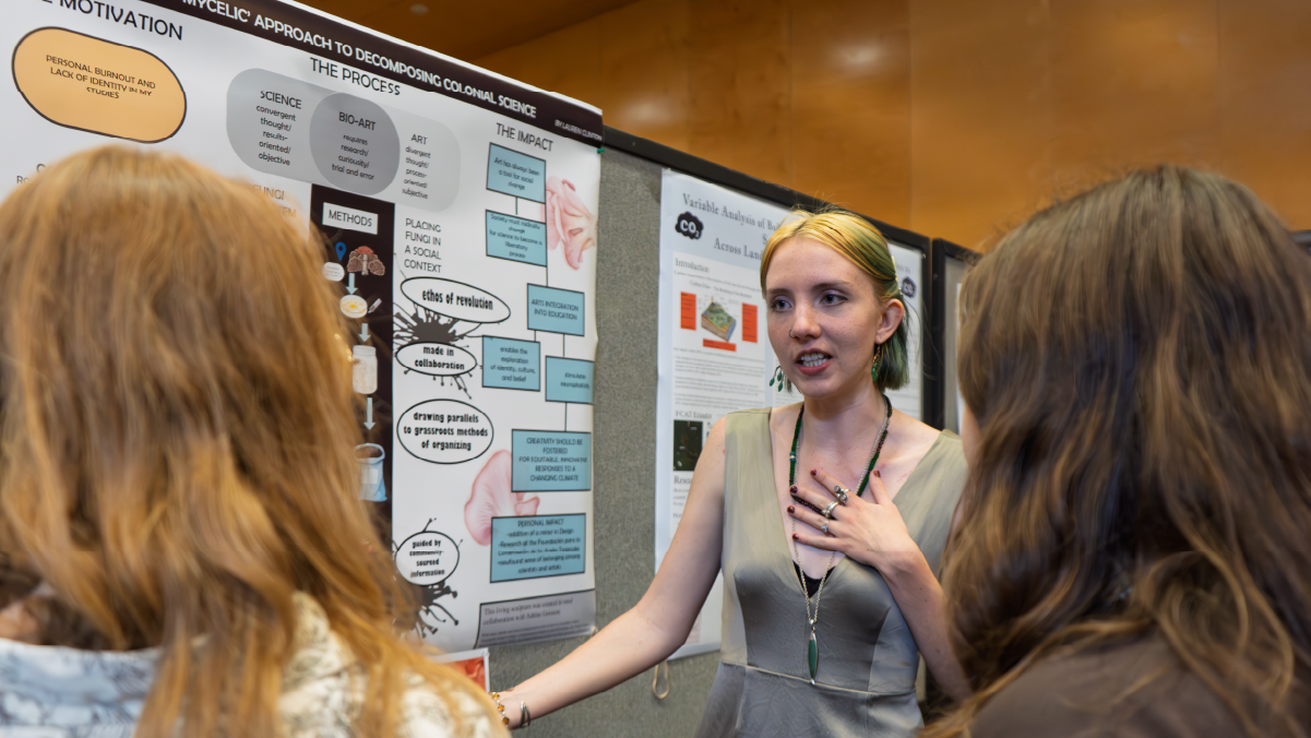 Student presenting research poster