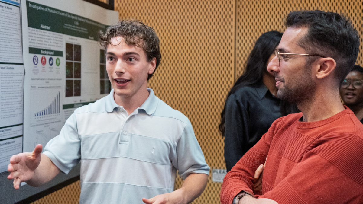 Student presenting research poster