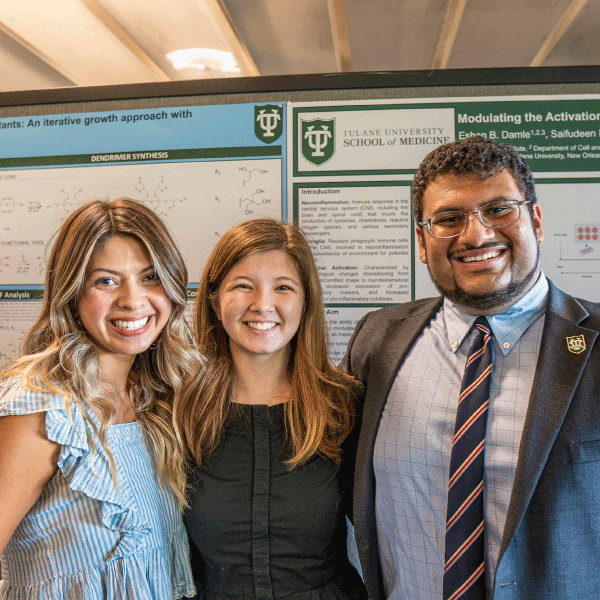 Students posing in front of research posters